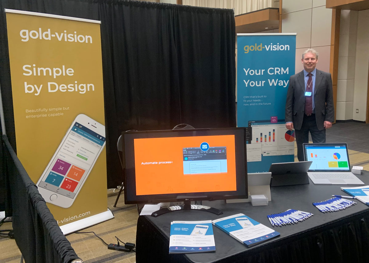 Charlie Shaw standing at the Gold-Vision booth