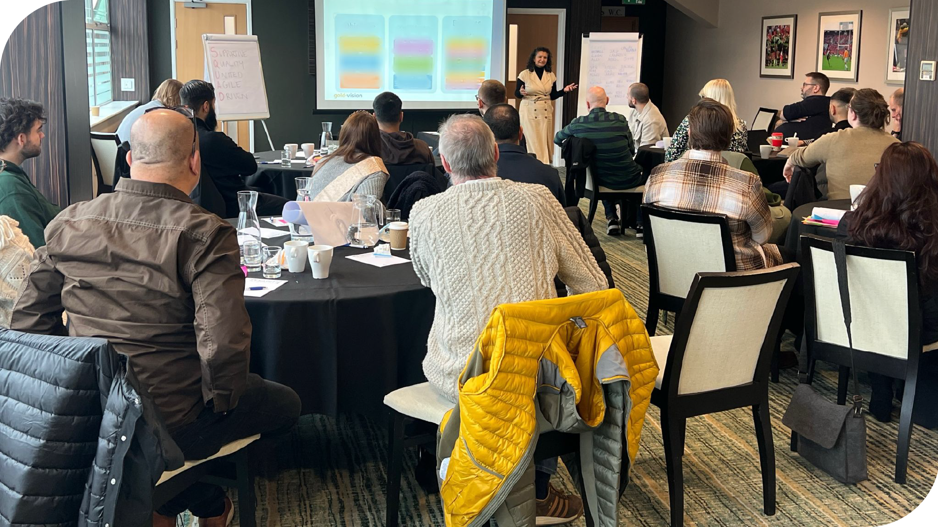 A photograph of the GV team at Franklin's Gardens for the Business Strategy Day listening to a session from Jiggy Patel. 